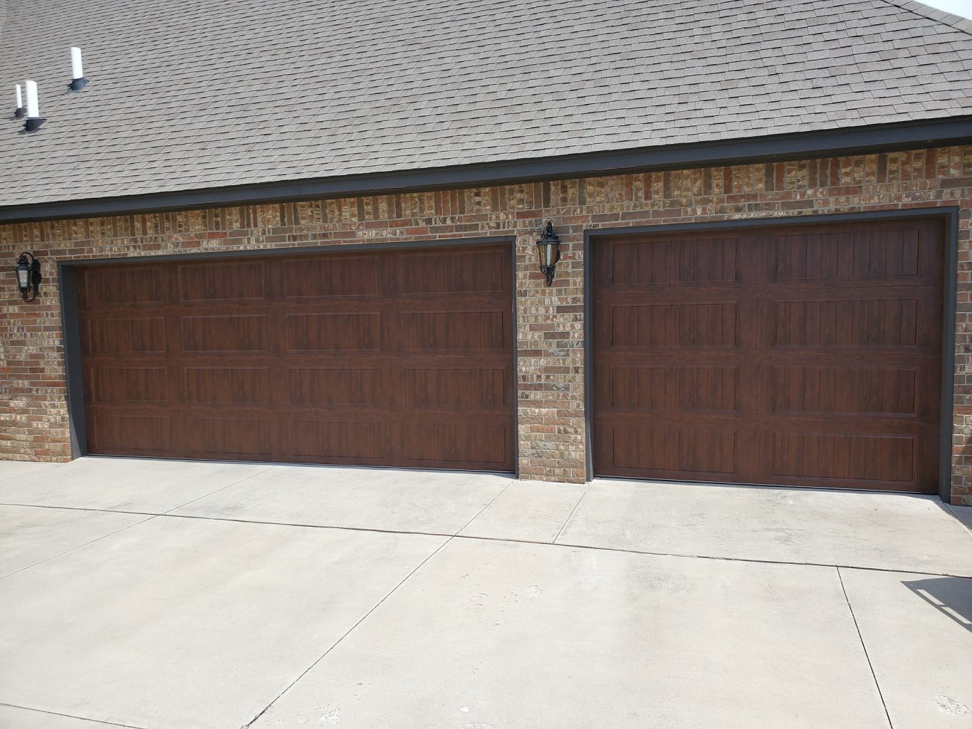 Walnut-finish garage door installed by Thunder Garage Door