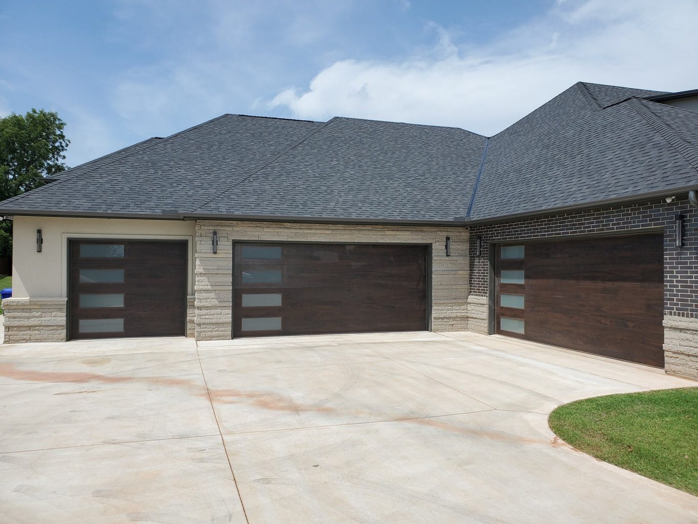Double walnut-finish garage doors on a new home